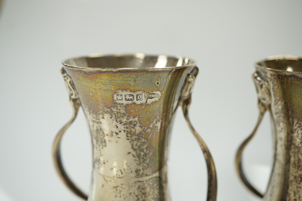 A pair of Edwardian Art Nouveau silver small vases, Walker & Hall, Sheffield, 1906, 10.1cm, 7.4oz. Condition - fair